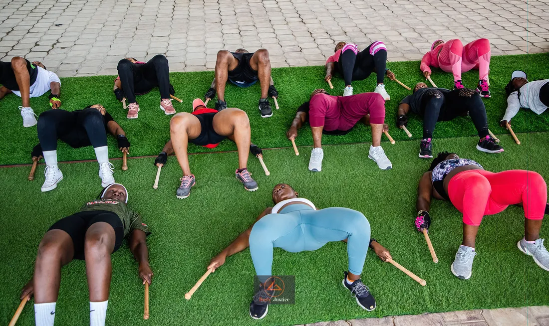 Body Justice Fitness participants moving together outdoors